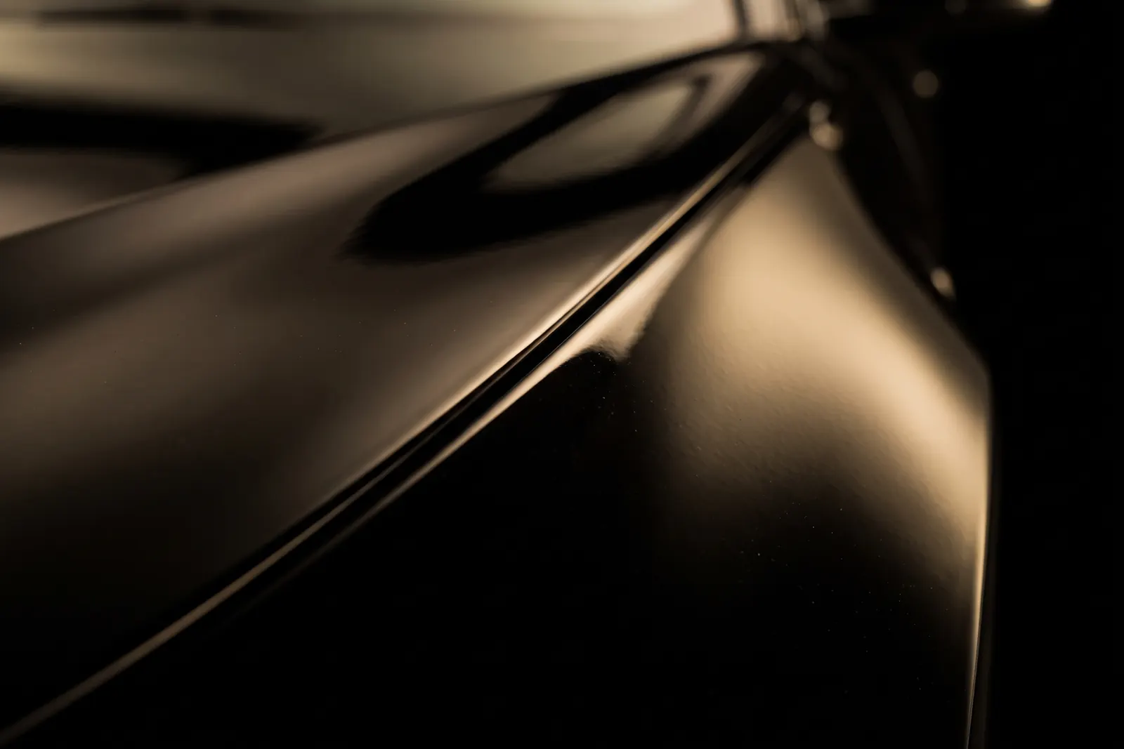 Macro of the same panel edge with the film wrapped behind it — no visible line