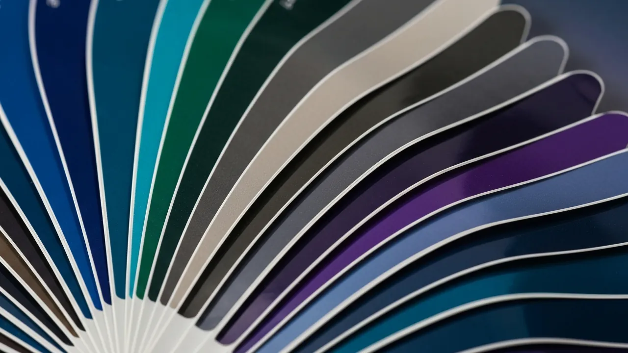 Fan of vinyl wrap colour swatches in gloss, satin and matte finishes at Obsidian Auto Calgary